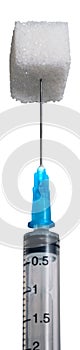 A piece of sugar on a needle syringe for a design of diets, sweet and diabetes problems isolated on a white background