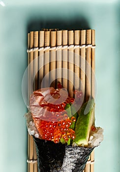 Piece of sushi ingredients: salmon, avocado, Masago. Flat view Close-up. Food concept. Copy space