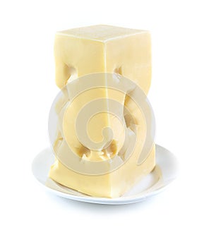 Piece of Swiss cheese on white plate on white background