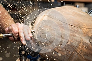 Piece of timber rotates to create wooden bowl photo