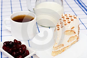 Piece of tiramisu cake on a white plate.