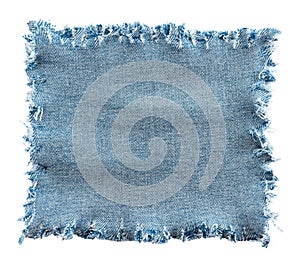 Piece of torn denim on a white background. Denim texture