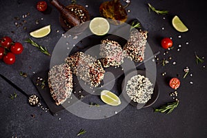 piece of tuna fillet covered with sesame seeds on a stone serving board before cooking