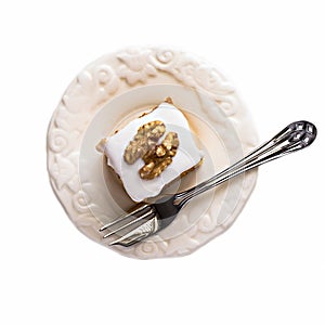 Piece walnut carrot cake and fork Isolated on white background.