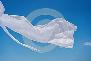 Piece of white airy fabric fluttering in the wind.