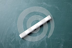 Piece of white chalk on greenboard