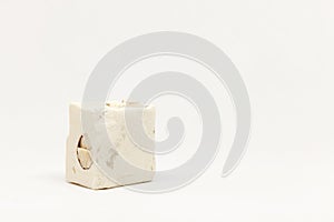 A piece of white nougat candy on light background