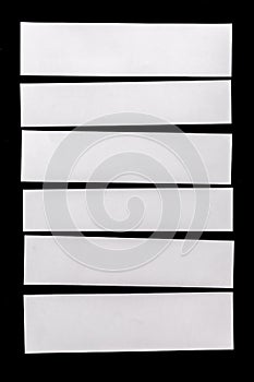 Piece of white paper isolated on black