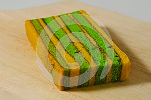 A piece of yellow-green lapis legit cake