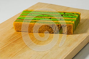 A piece of yellow-green lapis legit cake