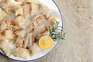 Pieced of sea fish filet on a white plate