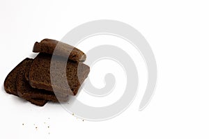 Pieces of black sourdough rye bread lie on a white background isolated