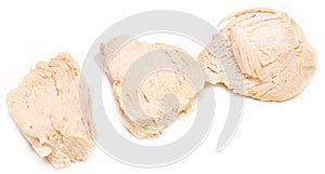 Pieces of boiled chicken breast over white background