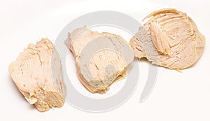 Pieces of boiled chicken breast over white background