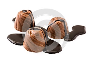 pieces of bonbons covered with melted chocolate isolated