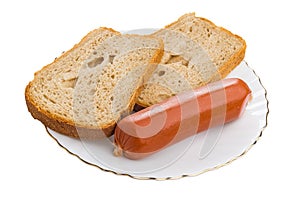 Pieces of bread, sausage on plate isolated on white background