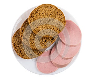 Pieces of bread, slices of sausage in plate isolated on white. Top view