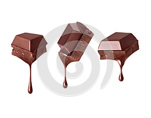 Pieces of broken chocolate bar with dripping drops close up isolated on a white background