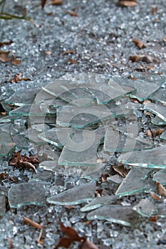 Pieces Of Broken Glass Lie On Ground At Vandalized Business photo
