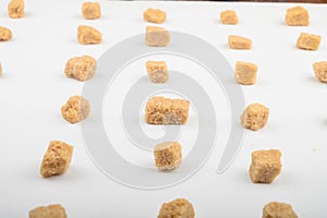 Pieces of brown sugar on a white background