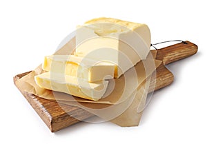 Pieces of butter on wooden cutting board