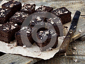 Pieces of cake chocolate brownies on wooden background. Homemade baking. Copy space