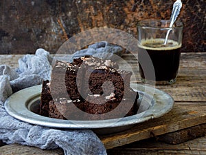 Pieces of cake chocolate brownies on wooden background. selective focus.