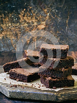 Pieces of cake chocolate brownies on wooden background. selective focus. copy space.