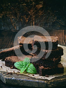 Pieces of cake chocolate brownies on wooden background. selective focus.