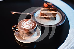 Pieces of cake. Drink hot chocolate cocoa coffee in cups. Black background.