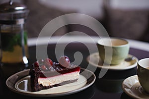 Pieces of cake. Drink hot chocolate cocoa coffee in cups. Black background.