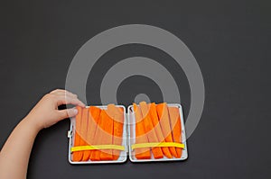 Carrots in a cigarette case. Smoking cessation concept, role model for children photo