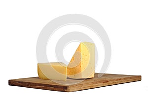 Pieces of cheese on a board.