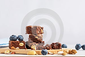 Pieces of chocolate brownie with peanuts