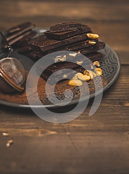 Pieces Of Chocolate  Chocolate Shavings And Strainer With Cocoa and peanuts