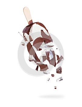 Pieces of chocolate ice cream are falling down on a white background