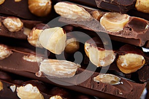 Pieces of chocolate with nuts, close-up delicacy