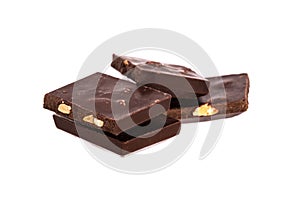 pieces of chocolate with nuts in a heap isolated on white background