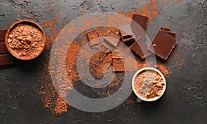 Pieces of chocolate on a table with mirrored chocolate powder