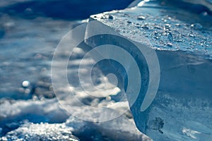 Pieces of clear blue ice of lake Baikal in the winter sunlight