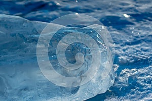 Pieces of clear blue ice of lake Baikal in the winter sunlight