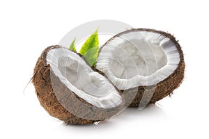 Pieces of coconut with green leaves closeup