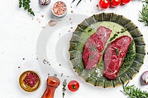 Pieces of cooked rump steak with spices served on old meat tray. Steak of marbled beef black Angus. Raw beef ramp steak, top view