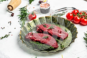 Pieces of cooked rump steak with spices served on old meat tray. Steak of marbled beef black Angus. Raw beef ramp steak, top view