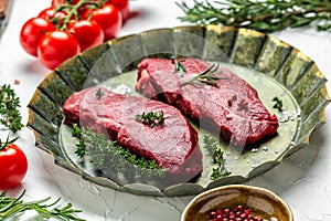 Pieces of cooked rump steak with spices served on old meat tray. Steak of marbled beef black Angus. Raw beef ramp steak, top view