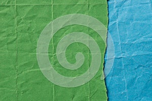 Pieces of creased green and blue paper background texture
