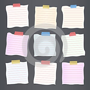 Pieces of crumpled cut colorful lined note paper are stuck on dark gray background