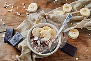 Pieces of dark chocolate and banana accompany light cereal breakfast