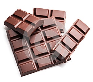 Pieces of dark chocolate bar isolated on white background. Sweet food is made of cocoa and sugar