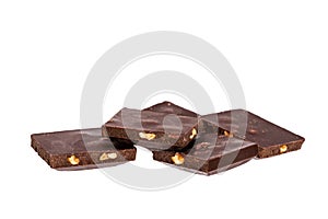 pieces of dark chocolate with nuts lie side by side isolated on white background